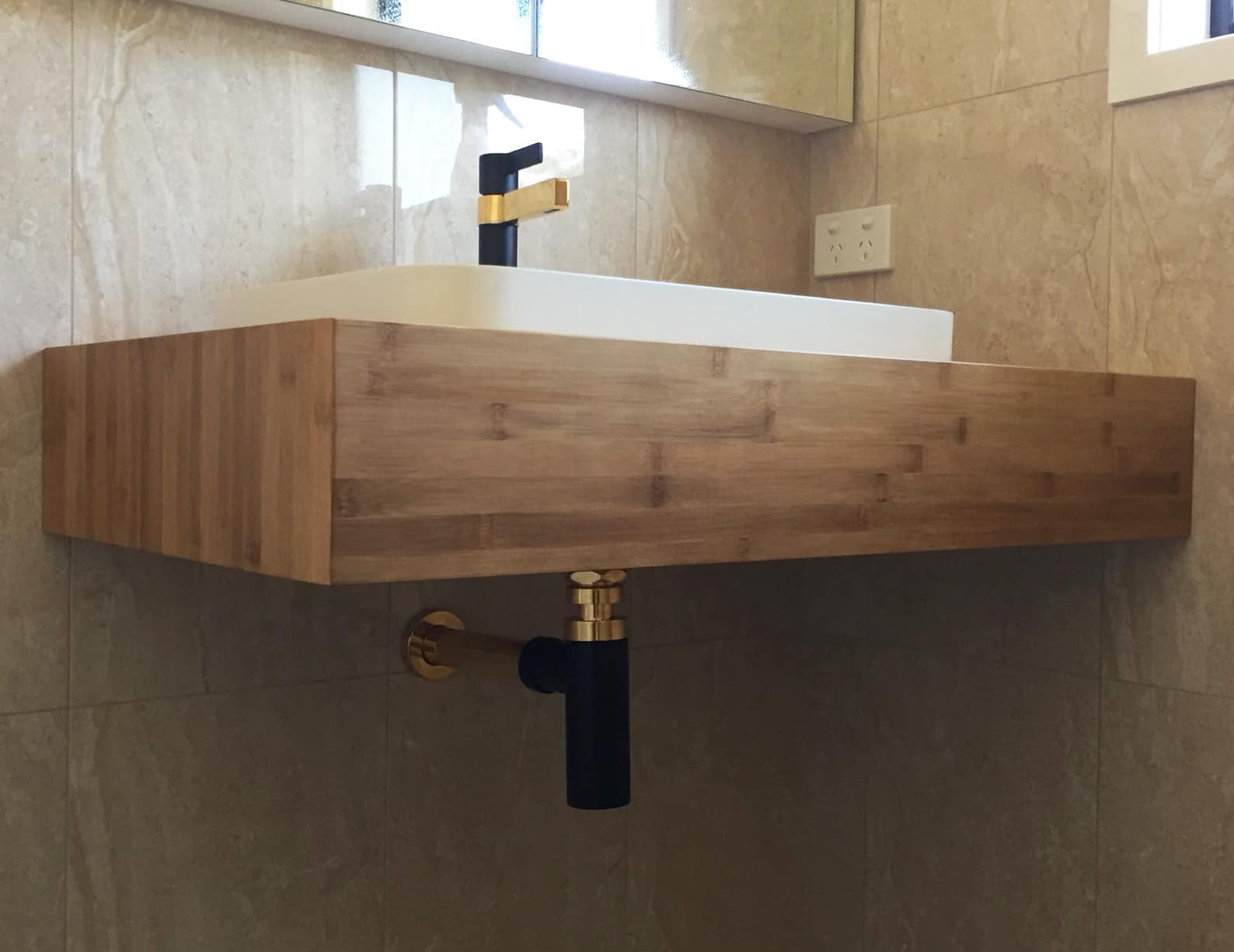 Bathroom vanity with gold tapware by Platinum Plumbing Newcastle
