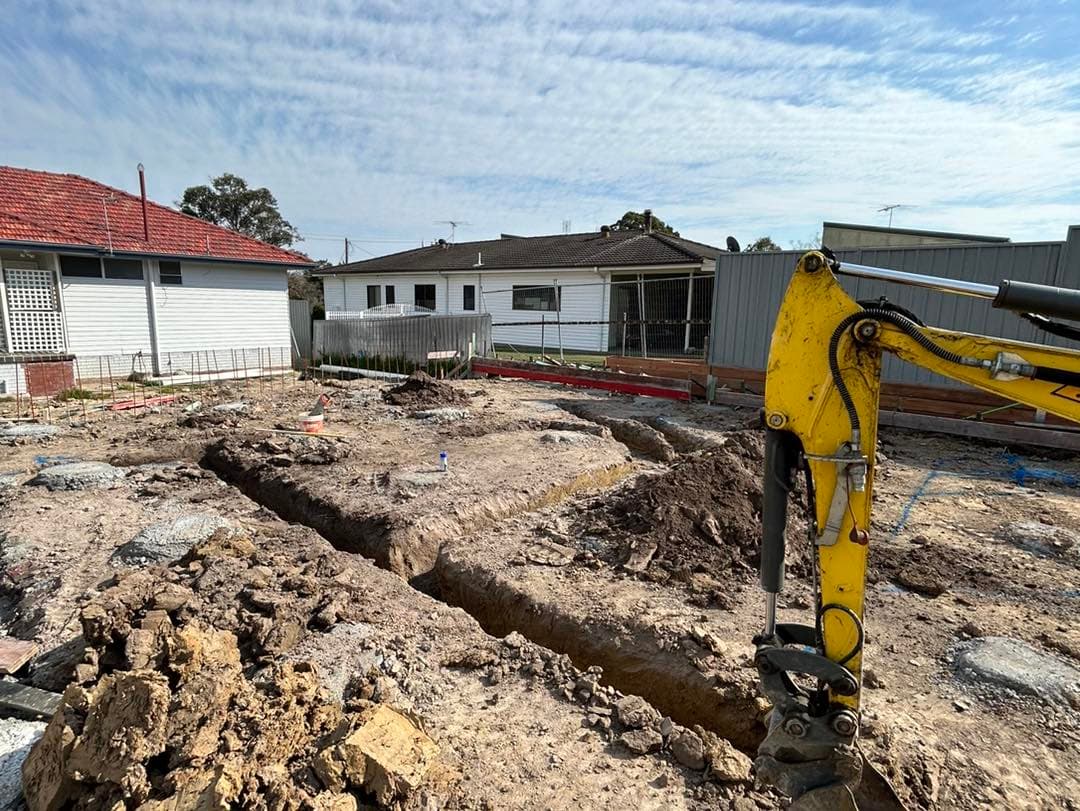 Multi-unit development excavation for plumbing infrastructure